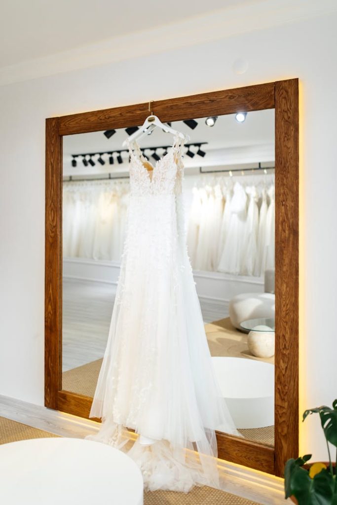 A beautiful wedding dress elegantly displayed in a modern bridal shop.
